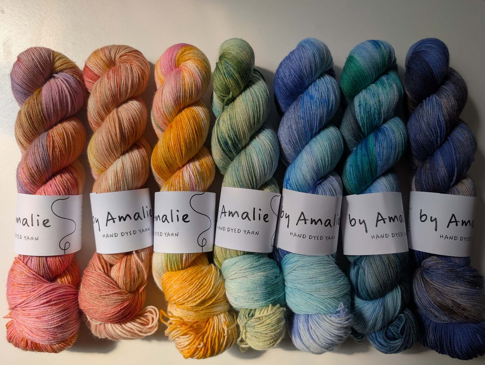 Skeins of hand dyed yarn by Amalie